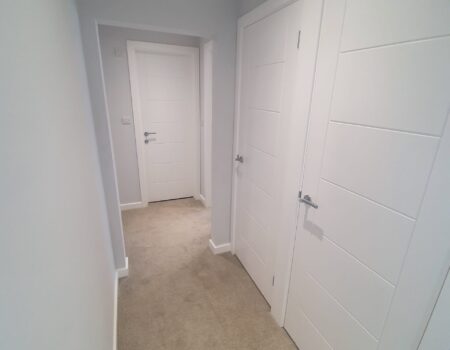 Top Drawer Construction bespoke carpentry white doors fitted in an apartment hallway Woking Weybridge Surrey