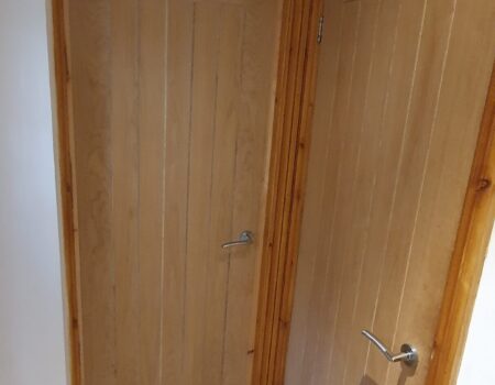 Top Drawer Construction bespoke carpentry wooden door fitting service in domestic hallway Ottershaw Surrey