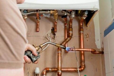 A local Top Drawer Construction plumber fixing and installing home boiler heating system Woking Weybridge Surrey