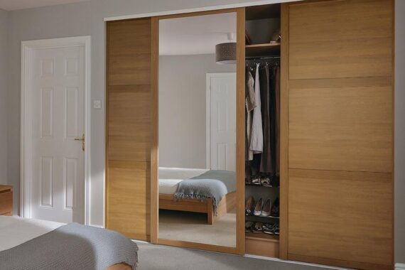 Built in bedroom wardrobes with wooden and mirrored sliding door installed by Top Drawer Construction Woking Weybridge Surrey